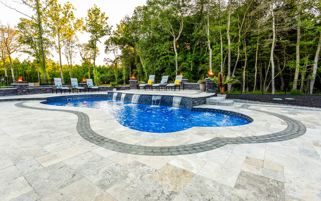 A Leisure Pools Eclipe fiberglass swimming pool with pool coping